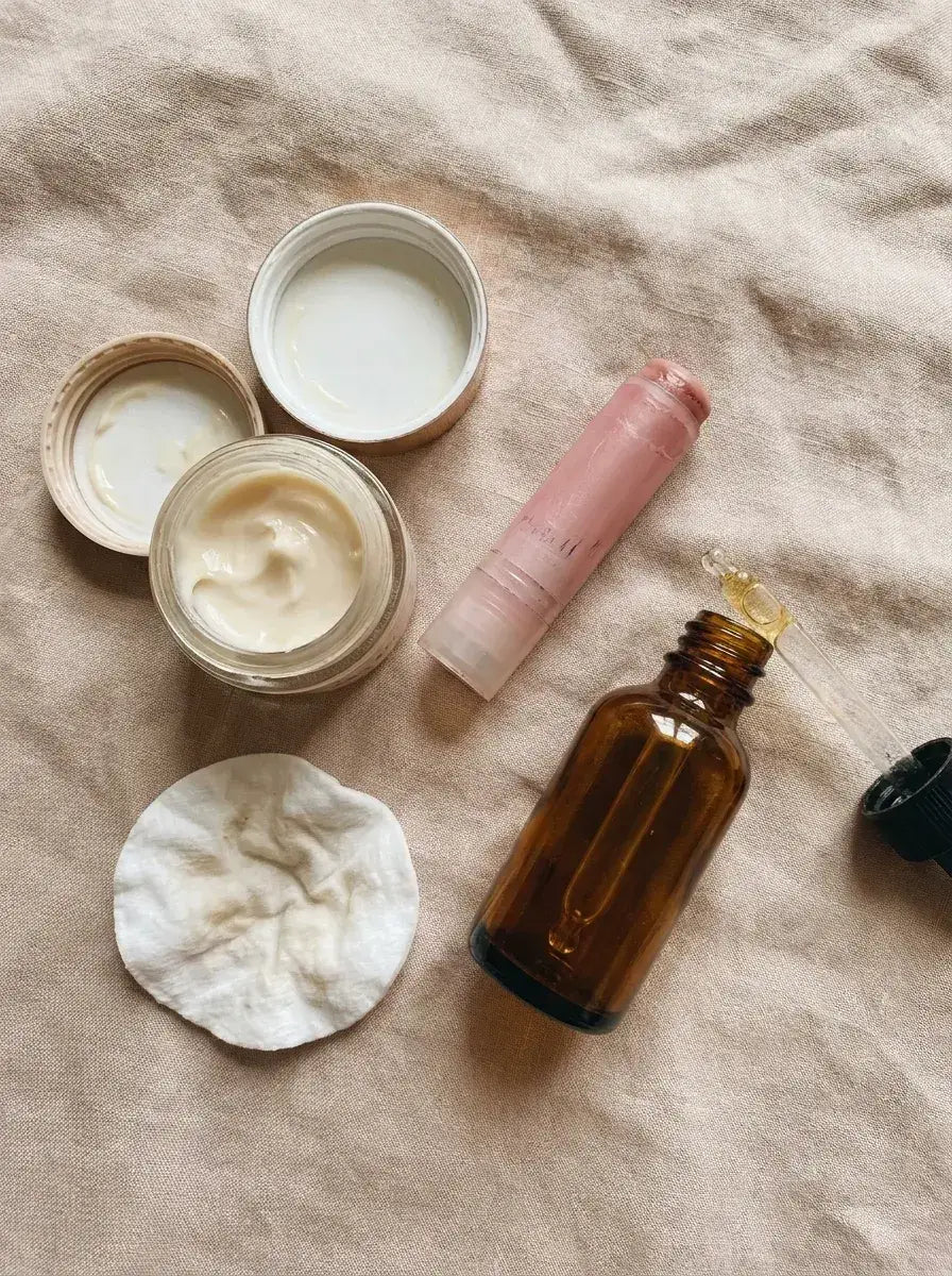 A flat-lay of half-used eye creams, drugstore lip balms and serum droppers