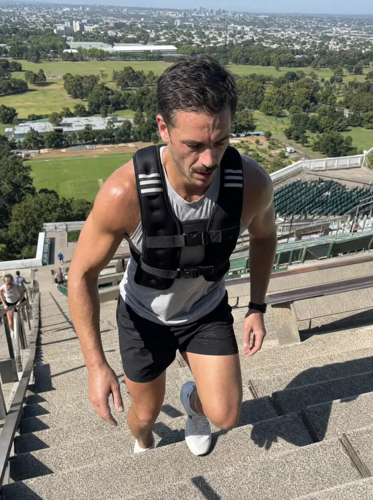 Marcus T. on outdoor stairs wearing the Givorn vest