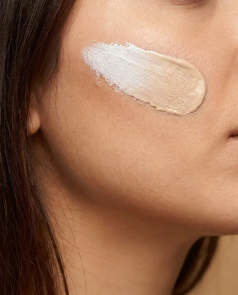 The white foundation warming toward her tone as she blends