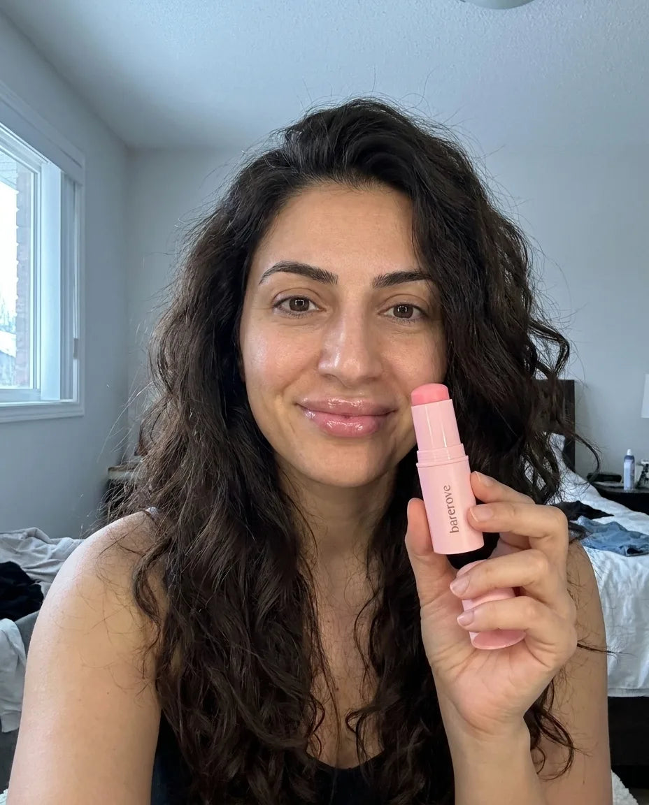 customer holding the balm stick, rested under eyes